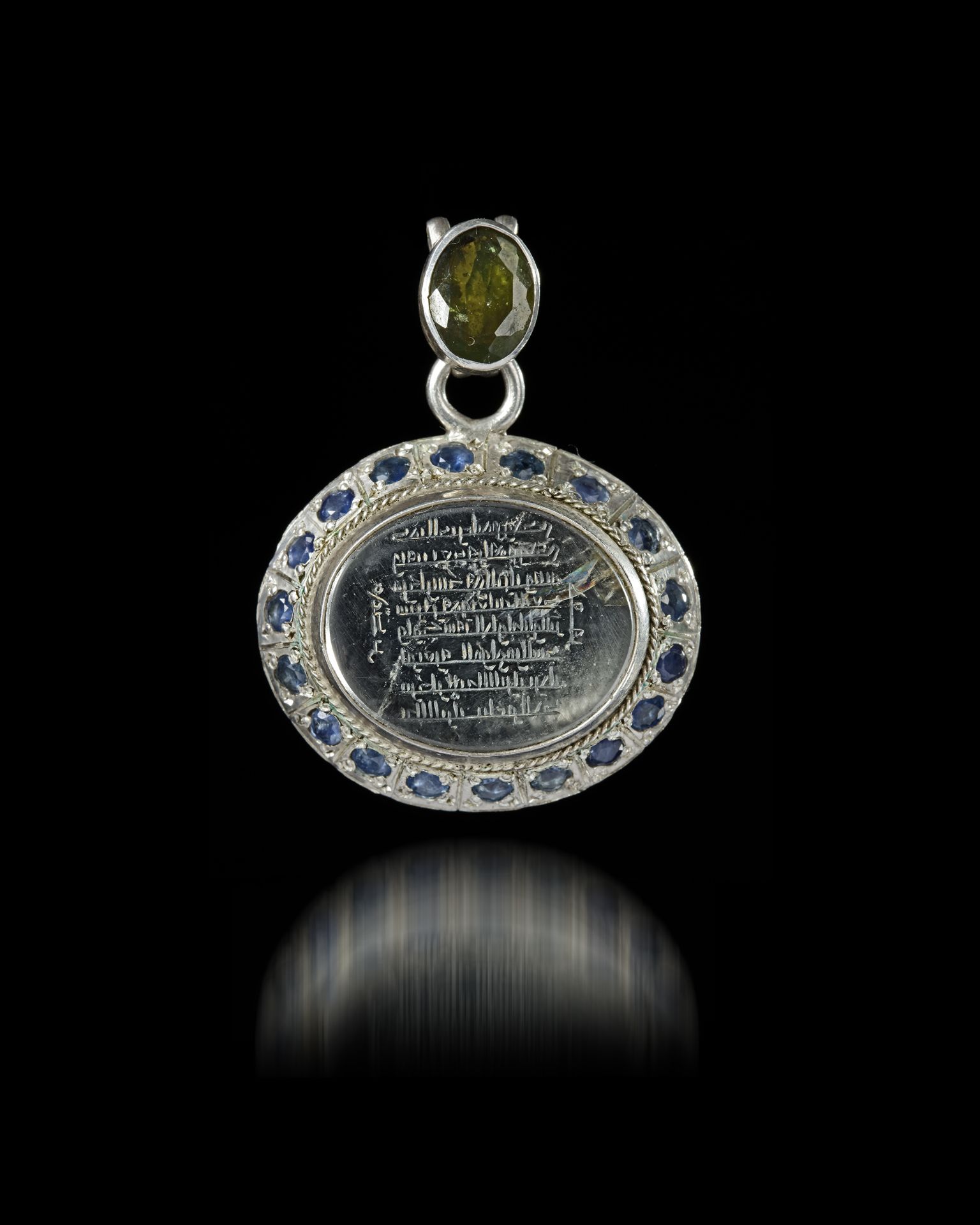 A CRYSTAL SILVER MOUNTED AND GEMSTONES- SET CARVED PENDANT, 4TH AH -11TH AD CENTURY