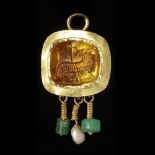 A BYZANTINE GOLD PENDANT WITH A TOPAZ INTAGLIO OF THE LAMB OF GOD, 5TH/6TH CENTURY AD