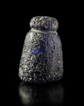 A CARVED GLASS CHESS PIECE, POSSIBLY A PAWN,10TH/11TH CENTURY