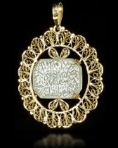 A GOLD MOUNTED TALISMANIC CARVED JADE PENDANT