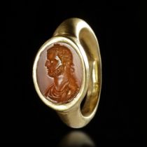 A ROMAN GOLD RING WITH A CARNELIAN INTAGLIO SHOWING THE HEAD OF AN EMPEROR, 4TH CENTURY AD