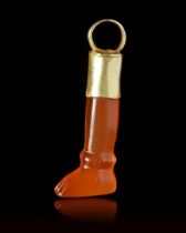 A CARNELIAN AMULET/SEAL IN THE SHAPE OF A LEG, CIRCA 700 BC