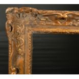 Early 18th Century French School. A Carved Giltwood and Painted Louis XIV Frame, rebate 32" x 25.25"