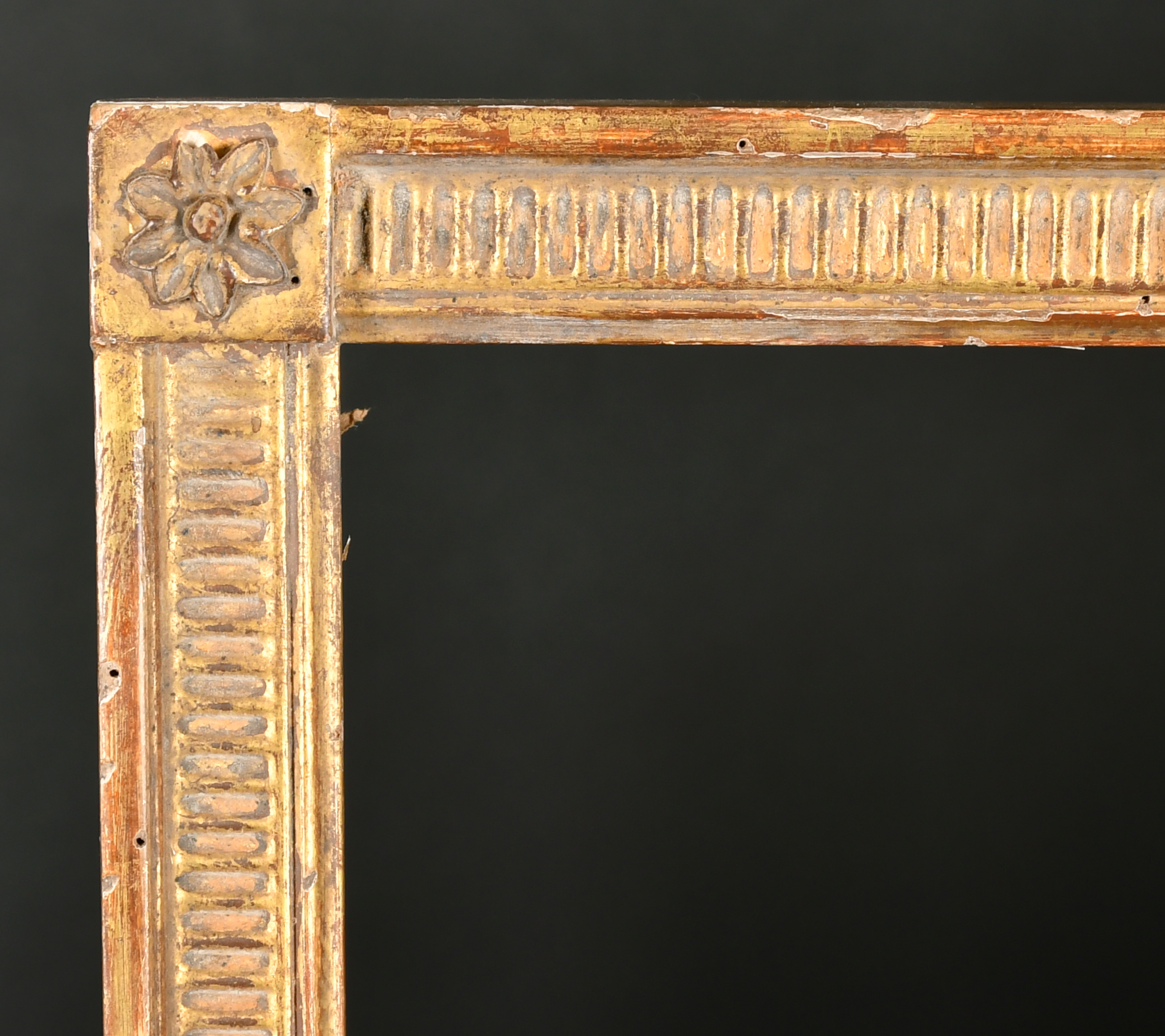 20th Century French School. A Louis Style Giltwood Frame, with flutes and paterae corners, rebate