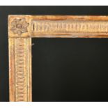 20th Century French School. A Louis Style Giltwood Frame, with flutes and paterae corners, rebate