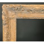 Early 18th Century English School. A Carved Giltwood Frame, with swept centres and corners, rebate