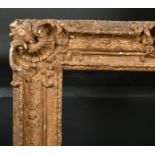 18th century French School. A Carved Giltwood Frame, with swept centres and corners, rebate 30" x