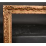 20th Century English School A Gilt Composition Frame, with swept centres and corners and a fabri
