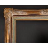 Early 20th Century European School. A Gilt Composition Frame, with swept centres and corners, rebate