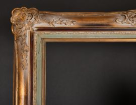 Early 20th Century European School. A Gilt Composition Frame, with swept centres and corners, rebate