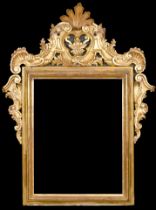 19th Century Italian School. A Carved Giltwood Frame, with a central pediment, and inset mirror