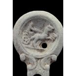 ROMAN TERRACOTTA OIL LAMP WITH CHARIOT SCENE AND MAKER'S MARK