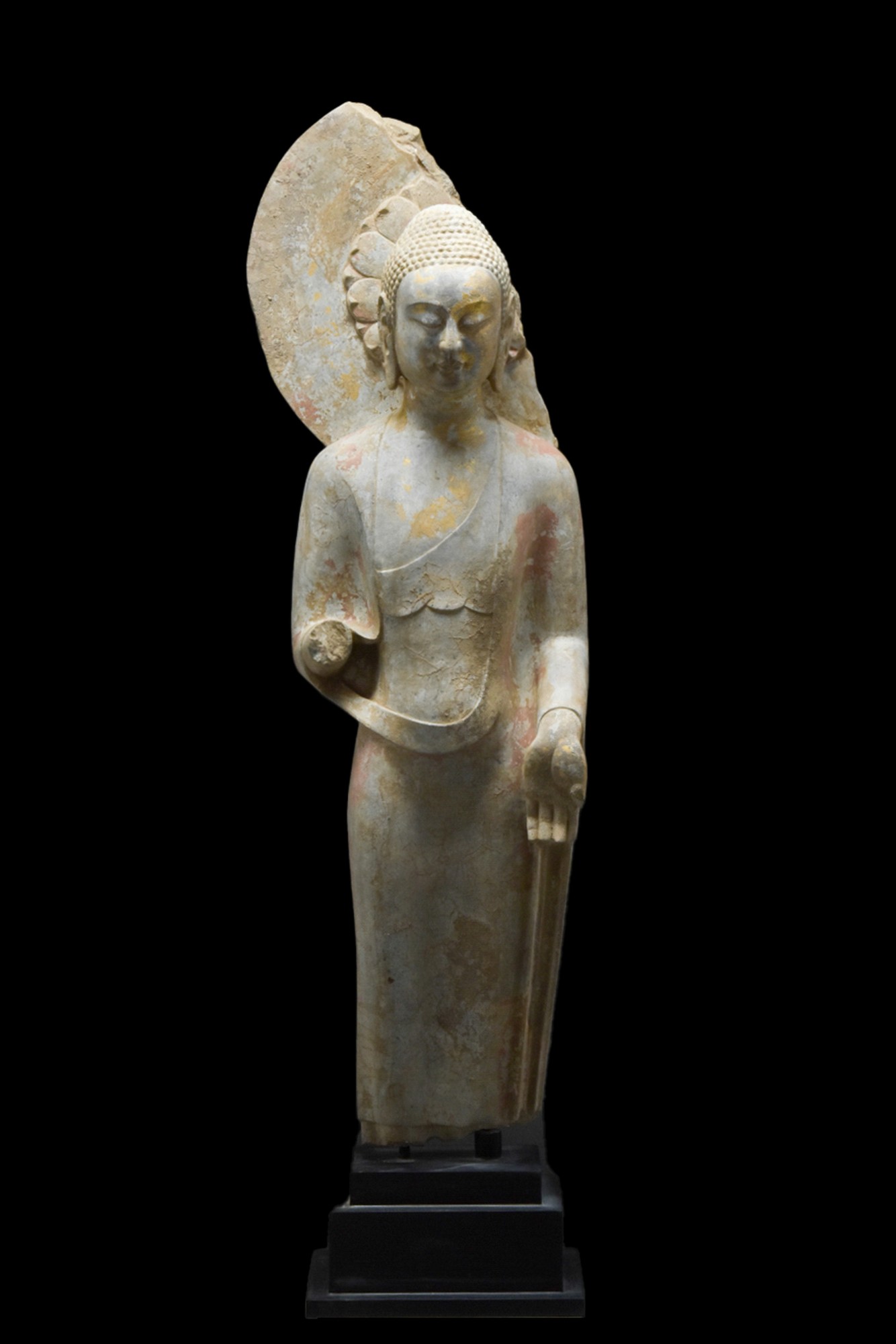 A LIMESTONE STANDING BUDDHA SCULPTURE