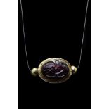 A CABOCHON GARNET WITH LEDA AND SWAN IN A GOLD MOUNT - WITH REPORT