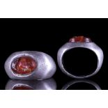 ROMAN SILVER RING WITH CARNELIAN INTAGLIO OF CUPID RIDING A HIPPOCAMPUS