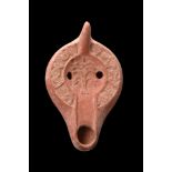 ROMAN TERRACOTTA OIL LAMP WITH A PALM TREE