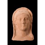 GREEK TERRACOTTA PROTOME OF A GODDESS