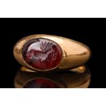 ROMAN GARNET INTAGLIO WITH A STAG IN GOLD RING