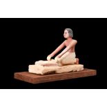 EGYPTIAN WOODEN MODEL OF A WOMAN GRINDING GRAIN