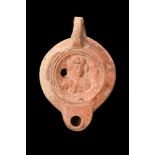 ROMAN RED-SLIPPED TERRACOTTA OIL LAMP WITH FEMALE BUST