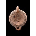 ROMAN TERRACOTTA OIL LAMP WITH AN EROTIC SCENE