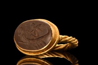 ROMAN INTAGLIO OF WINGED GOD IN A BOAT IN LATER GOLD RING