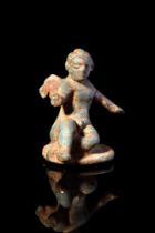 ROMAN BRONZE SEATED CUPID FIGURINE