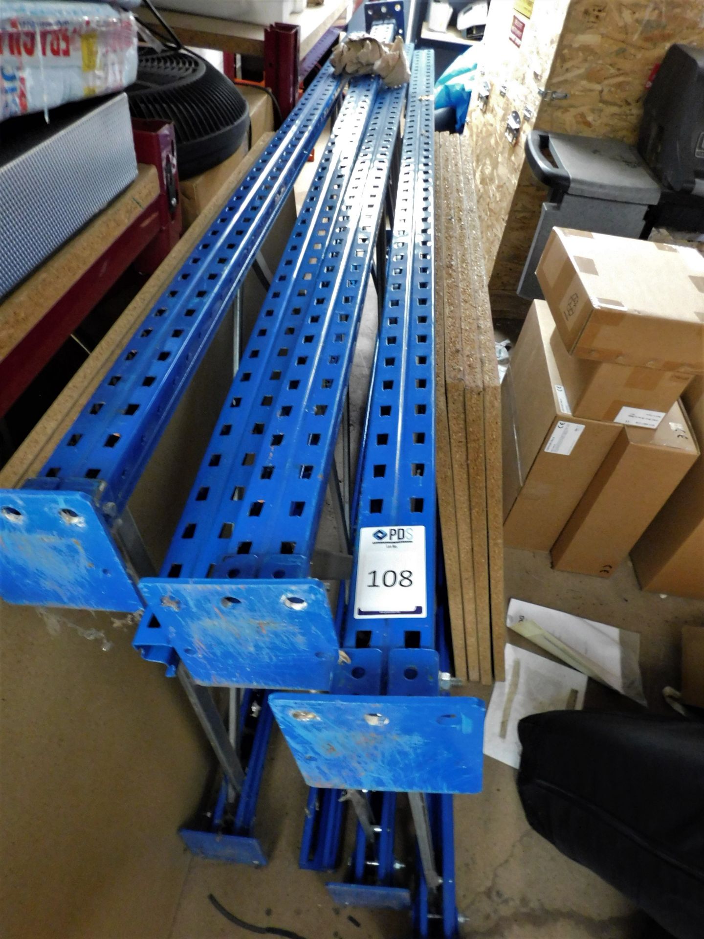 4 Boltless Metal Racking Uprights & 4 Chipboard Shelves (Location: Bushey. Please Refer to General