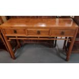 Modern hardwood Chinese console/side table having three drawers standing standing on square legs.