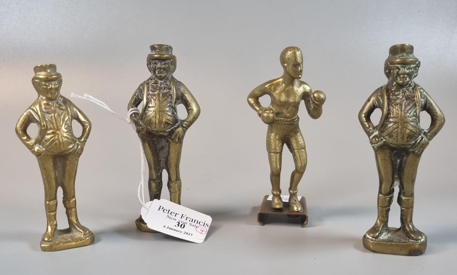 Three brass figures of John Bull. Together with a car mascot of a brass boxing figure. (4) (B.P. 21%