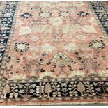 Middle Eastern design blue and salmon ground carpet overall with stylised floral and foliate