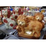 Two similar Staffordshire style pottery fireside Spaniels with painted features. Along with a pair
