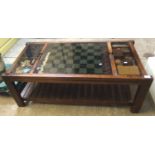 Modern stained wooden glass top coffee and games table containing chess pieces and other games