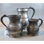 Three 19th Century pewter pot bellied tankards. The largest 25cm high approx and marked 1 gallon. (