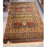 Middle Eastern design salmon ground and multicoloured geometric runner/carpet. 114x173cm approx. (