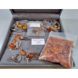 Collection of silver and amber jewellery items: bracelets, ring, earrings, brooch, amber beads