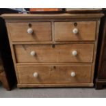 Late Victorian pine straight front chest of two short and two long drawers with ceramic nob handles.