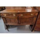 Late 19th early 20th century mahogany bow front side board standing on tapering legs and splayed