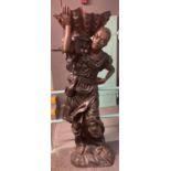 Pair of life sized patinated hollow cast bronze Blackamoor figures, men carrying large clam