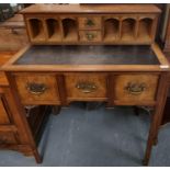 Unusual early 20th century walnut knee hole desk, the gallery back with fitted pigeon holes and