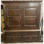 18th century oak two stage vestment cupboard, the moulded cornice above two blind panelled and
