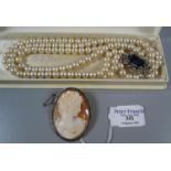 A shell cameo brooch and a cased set of simulated pearls. (B.P. 21% + VAT)