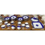 Three trays of Wedgwood blue and gilt dinner and teaware items, to include: various plates, saucers,