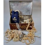Biscuit tin containing assorted costume jewellery, simulated pearl necklaces and other items. (B.