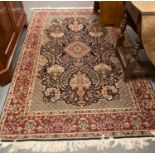 Persian carpet on a multicoloured ground with central medallion, overall decorated with flowers