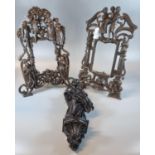 Pair of cast metal easel picture frames, overall decorated with mythical and other figures.