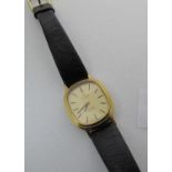 Omega gold plated lady's oval faced Deville quartz wristwatch with leather strap. Lacks crown.