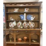 Miniature oak pot board dresser with assorted miniature china, copper and brass wear. (B.P. 21% +