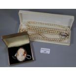 A shell cameo brooch and a string of simulated pearls. (B.P. 21% + VAT)