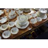 Two trays of Coalport part dinnerware, florally and gilt decorated: eleven saucers and eight cups,